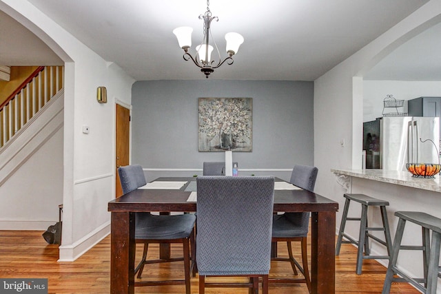 4527 Devereaux St, Philadelphia, PA 19135 - dining area featuring arched walkways, wood finished floors, and baseboards
