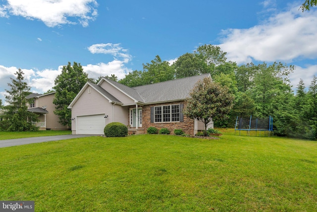 134 Whitaker Ave, North East, MD 21901 - view of front of home with a trampoline, asphalt driveway, a front lawn, and an attached garage