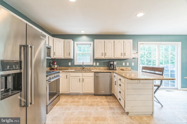 134 Whitaker Ave, North East, MD 21901 - kitchen with appliances with stainless steel finishes, a sink, a peninsula, light stone countertops, and recessed lighting
