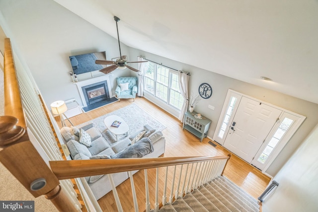 134 Whitaker Ave, North East, MD 21901 - living room featuring a ceiling fan, plenty of natural light, vaulted ceiling, wood finished floors, and a glass covered fireplace