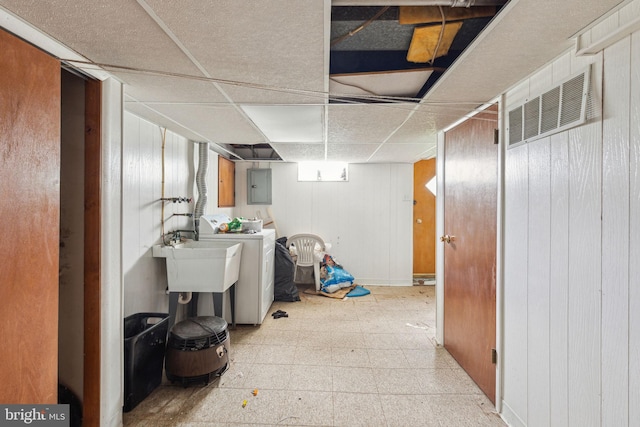 310 Passmore St, Philadelphia, PA 19111 - finished below grade area featuring electric panel, a drop ceiling, tile patterned floors, and wooden walls