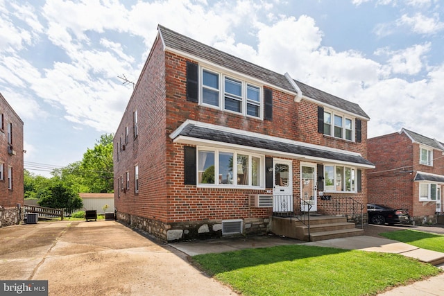 310 Passmore St, Philadelphia, PA 19111 - view of front facade with brick siding, cooling unit, and a front lawn
