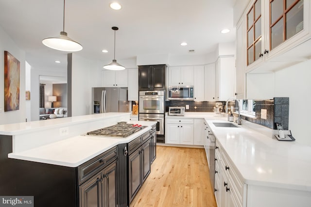 16340 Sandy Ridge Ct, Woodbridge, VA 22191 - kitchen with a sink, appliances with stainless steel finishes, white cabinetry, backsplash, and light countertops