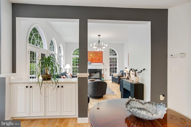 16340 Sandy Ridge Ct, Woodbridge, VA 22191 - dining area featuring a chandelier, light wood-style floors, and a glass covered fireplace