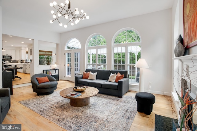 16340 Sandy Ridge Ct, Woodbridge, VA 22191 - living room featuring plenty of natural light, light wood finished floors, a fireplace, french doors, and recessed lighting