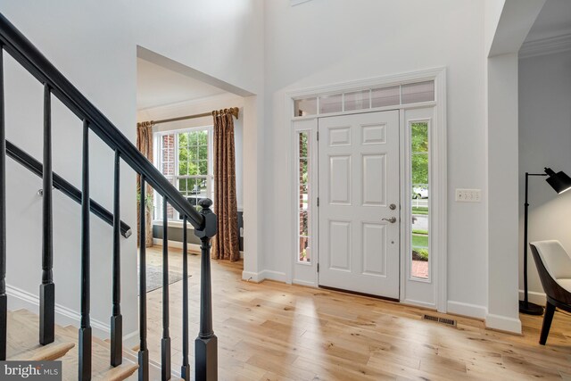 16340 Sandy Ridge Ct, Woodbridge, VA 22191 - foyer with light wood-style floors, baseboards, stairway, and ornamental molding