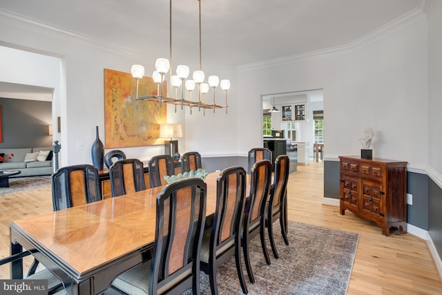 16340 Sandy Ridge Ct, Woodbridge, VA 22191 - dining area featuring light wood-type flooring, a chandelier, ornamental molding, and baseboards