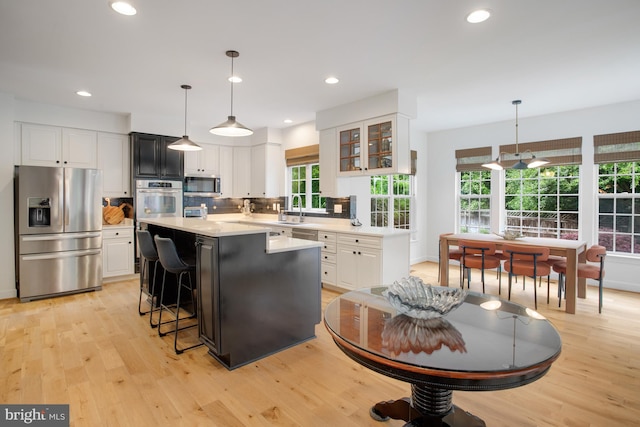 16340 Sandy Ridge Ct, Woodbridge, VA 22191 - kitchen featuring stainless steel appliances, light countertops, a kitchen breakfast bar, white cabinets, and recessed lighting