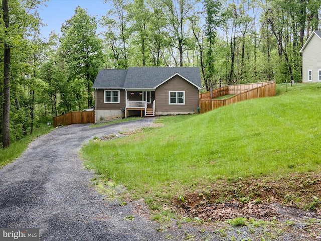 view of front of home with a porch, driveway, and a shingled roof