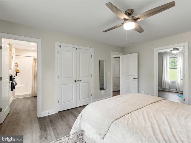 bedroom with wood finished floors, a closet, baseboards, connected bathroom, and a ceiling fan