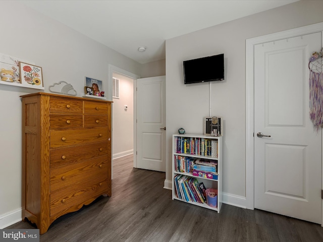 bedroom featuring dark wood-type flooring and baseboards