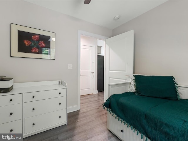bedroom featuring wood finished floors and baseboards