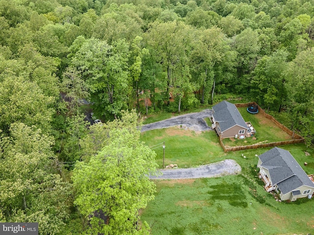 view of subject property with a heavily wooded area