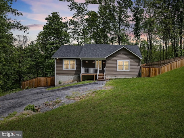 view of front of property featuring a porch and roof with shingles