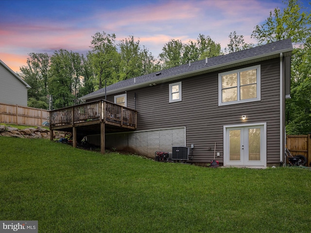 rear view of house featuring a wooden deck, french doors, and central AC