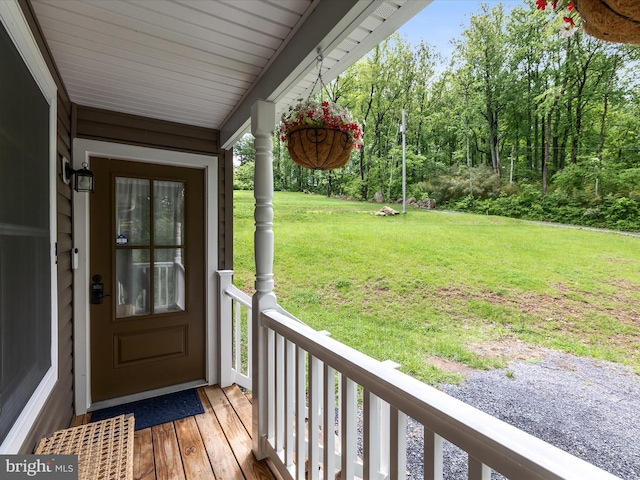 wooden deck with a yard and covered porch
