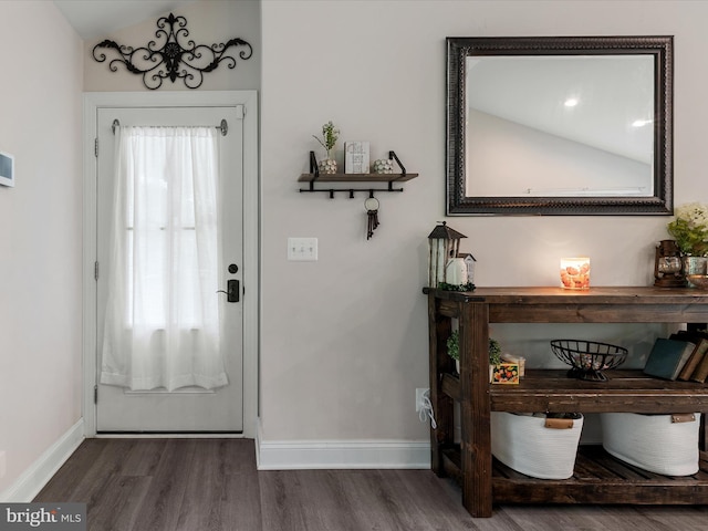 entryway featuring dark wood-type flooring and baseboards
