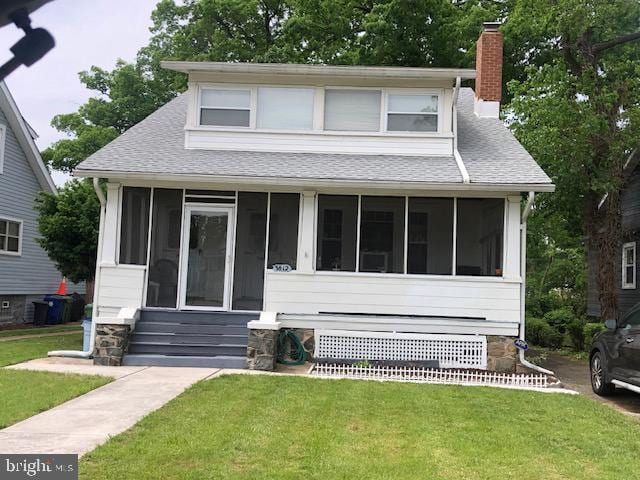 3812 Gwynn Oak Ave, Baltimore, MD 21207 - bungalow-style house with a sunroom, a shingled roof, a chimney, and a front yard