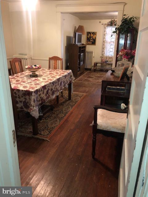 3812 Gwynn Oak Ave, Baltimore, MD 21207 - dining area with hardwood / wood-style flooring and radiator heating unit