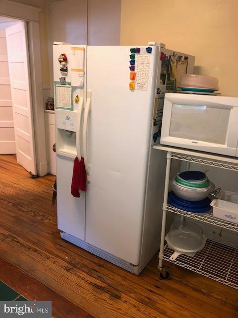 3812 Gwynn Oak Ave, Baltimore, MD 21207 - kitchen with white appliances and wood finished floors