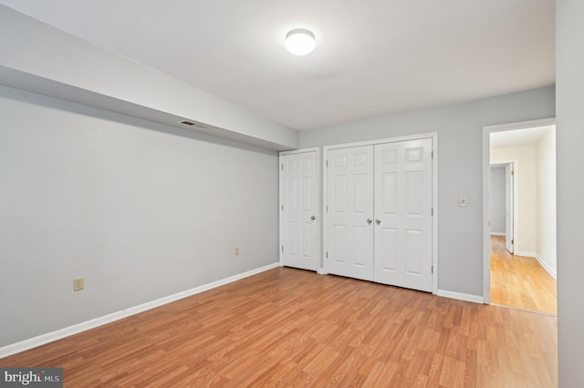 1037 William St, Baltimore, MD 21230 - unfurnished bedroom featuring light wood-type flooring, baseboards, and a closet