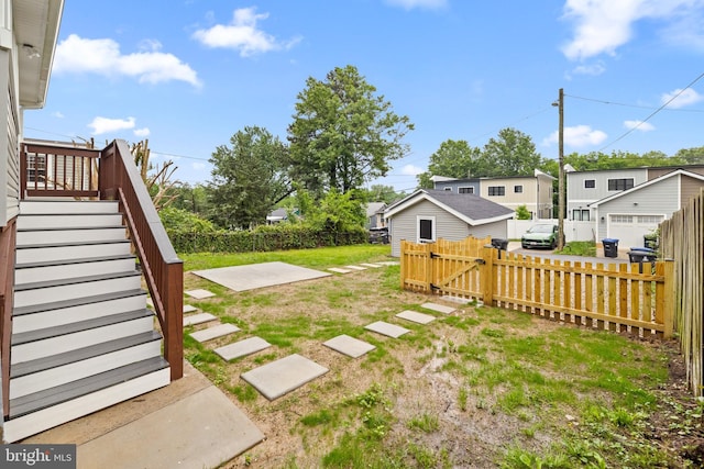 view of yard featuring stairs and a residential view