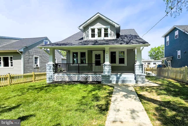 bungalow-style home with a porch and roof with shingles