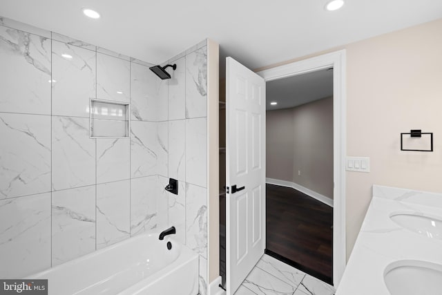 bathroom featuring a sink, recessed lighting, marble finish floors, shower / tub combination, and baseboards
