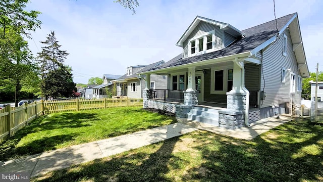view of front of house featuring covered porch and a shingled roof