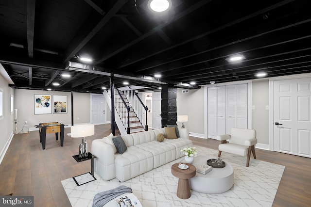 living room with wood finished floors, stairway, and baseboards