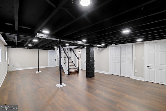 basement with baseboards, stairway, and wood finished floors
