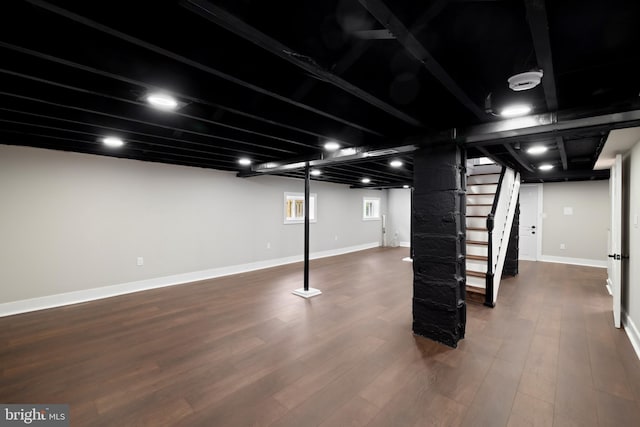 basement with stairs, wood finished floors, and baseboards