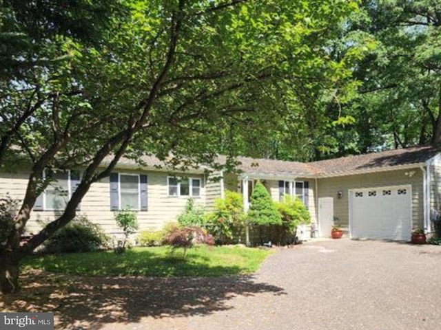 view of front facade with an attached garage and asphalt driveway