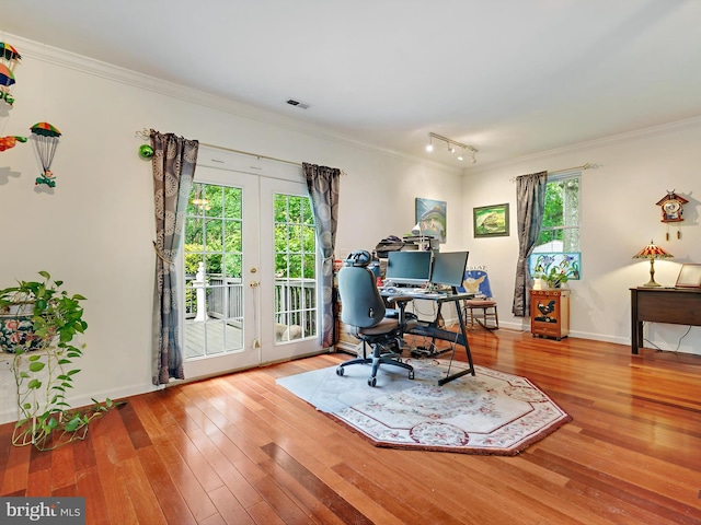 home office featuring french doors, hardwood / wood-style flooring, ornamental molding, track lighting, and baseboards