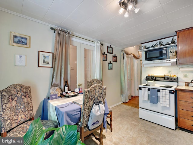 kitchen with white range with electric cooktop, black microwave, extractor fan, tasteful backsplash, and brown cabinets
