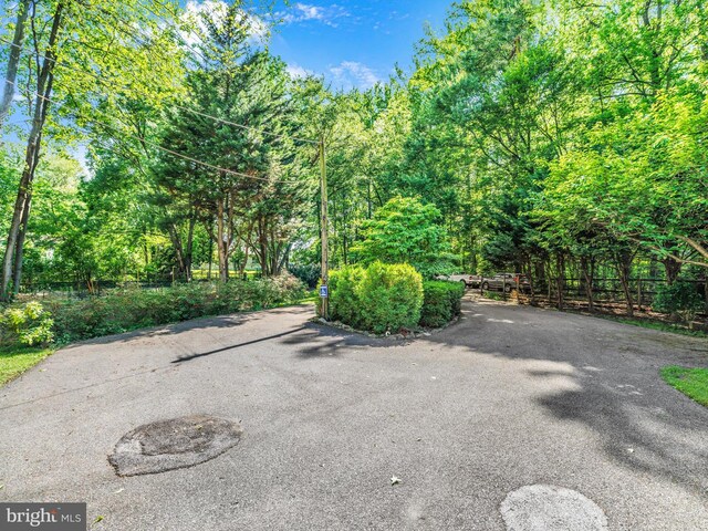 view of patio with a view of trees and fence