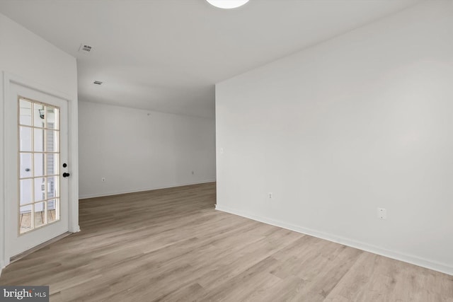 empty room featuring light wood-style floors and baseboards