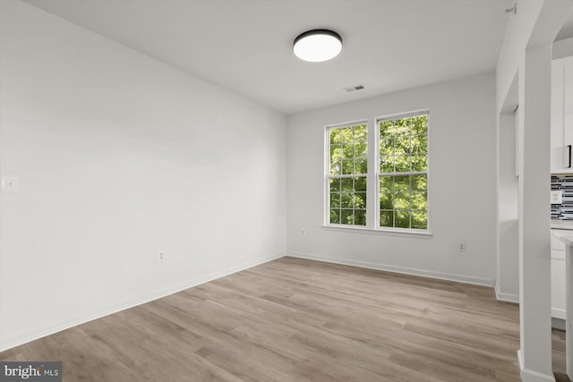 unfurnished dining area featuring light wood-style floors and baseboards