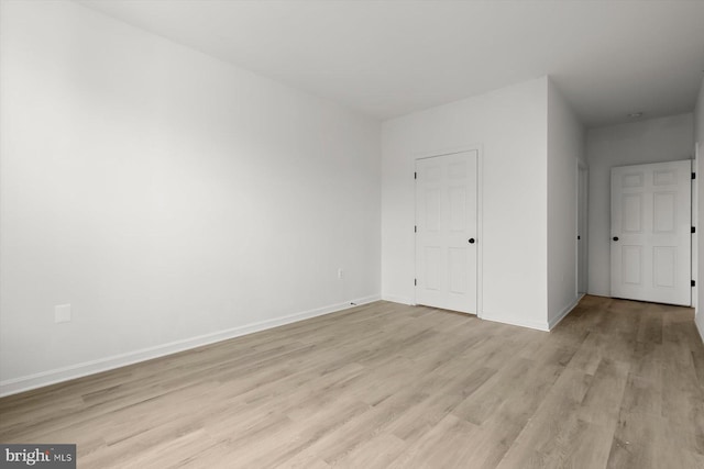 unfurnished bedroom with light wood-style floors and baseboards