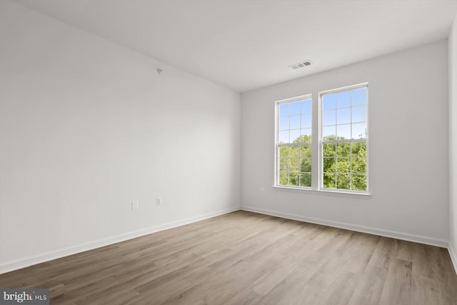 unfurnished room with wood finished floors and baseboards