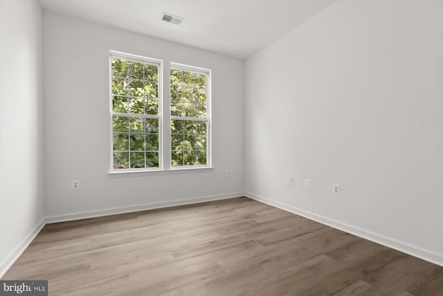 empty room with light wood-style flooring and baseboards