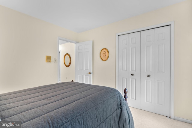 bedroom with light carpet and a closet