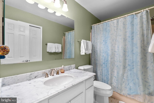 full bath with toilet, vanity, and tile patterned floors
