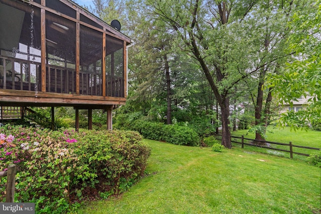 view of yard with a sunroom and stairs
