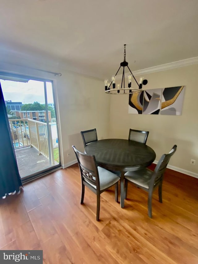 2624 Redcoat Dr Unit 2B, Alexandria, VA 22303 - dining space featuring a chandelier, baseboards, light wood-type flooring, and crown molding