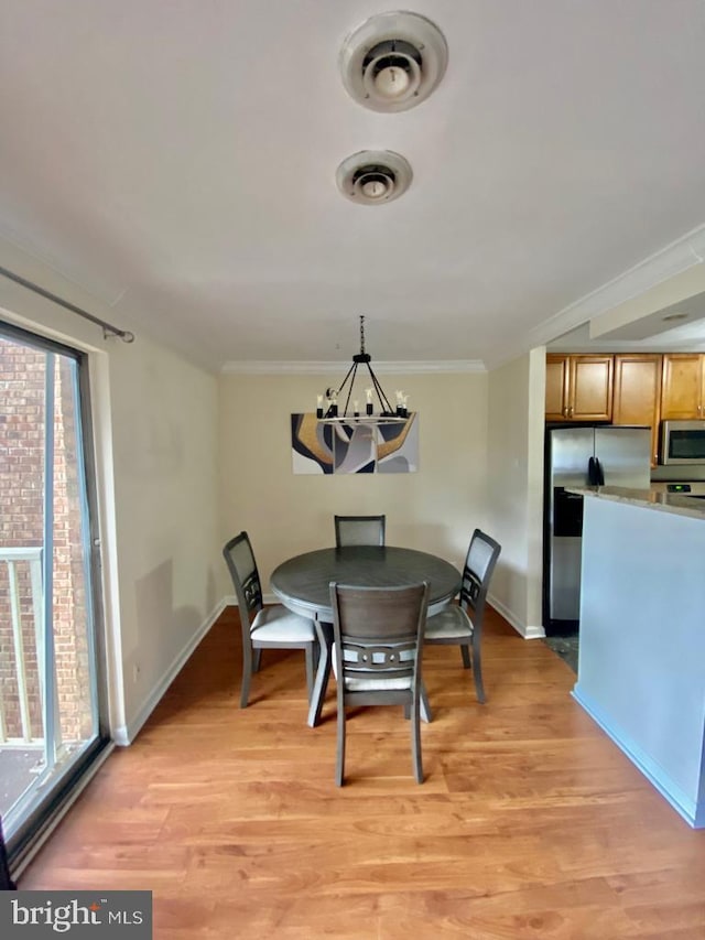2624 Redcoat Dr Unit 2B, Alexandria, VA 22303 - dining space with a chandelier, light wood finished floors, crown molding, and baseboards