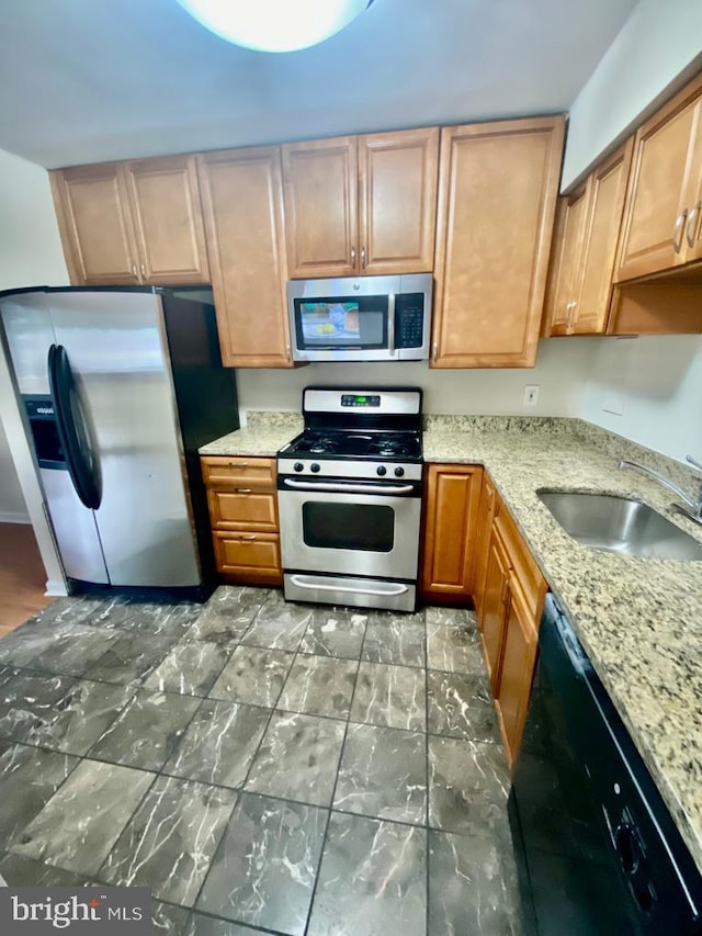 2624 Redcoat Dr Unit 2B, Alexandria, VA 22303 - kitchen with appliances with stainless steel finishes, a sink, and light stone counters