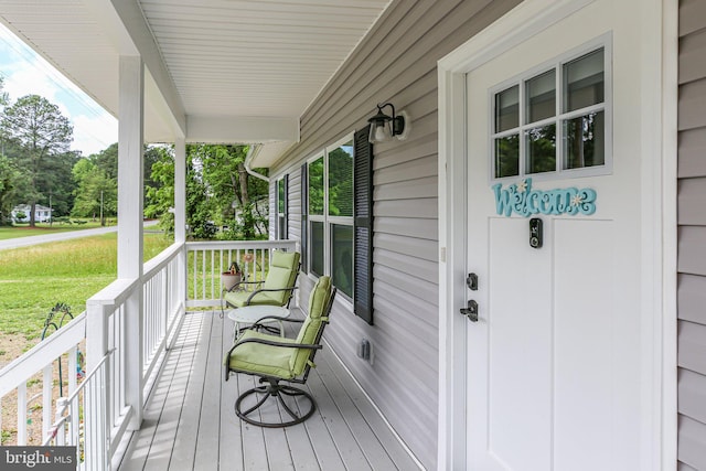 309 N Glebe Rd, Montross, VA 22520 - deck with covered porch, a yard, and view of scattered trees