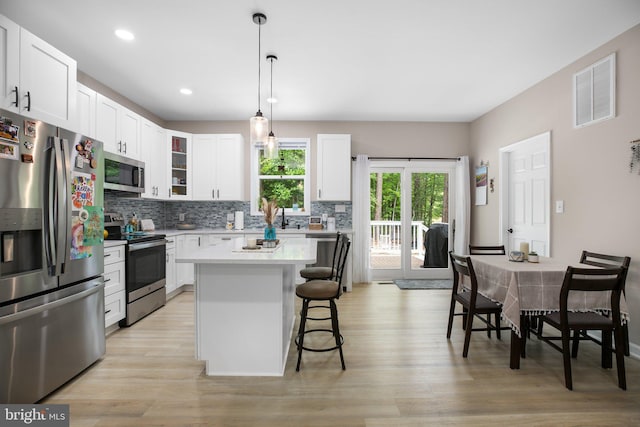 309 N Glebe Rd, Montross, VA 22520 - kitchen featuring appliances with stainless steel finishes, a breakfast bar area, light wood-type flooring, tasteful backsplash, and recessed lighting