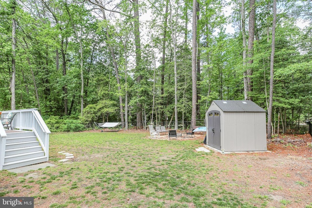 309 N Glebe Rd, Montross, VA 22520 - view of yard with a shed, an outbuilding, a fire pit, and a wooden deck